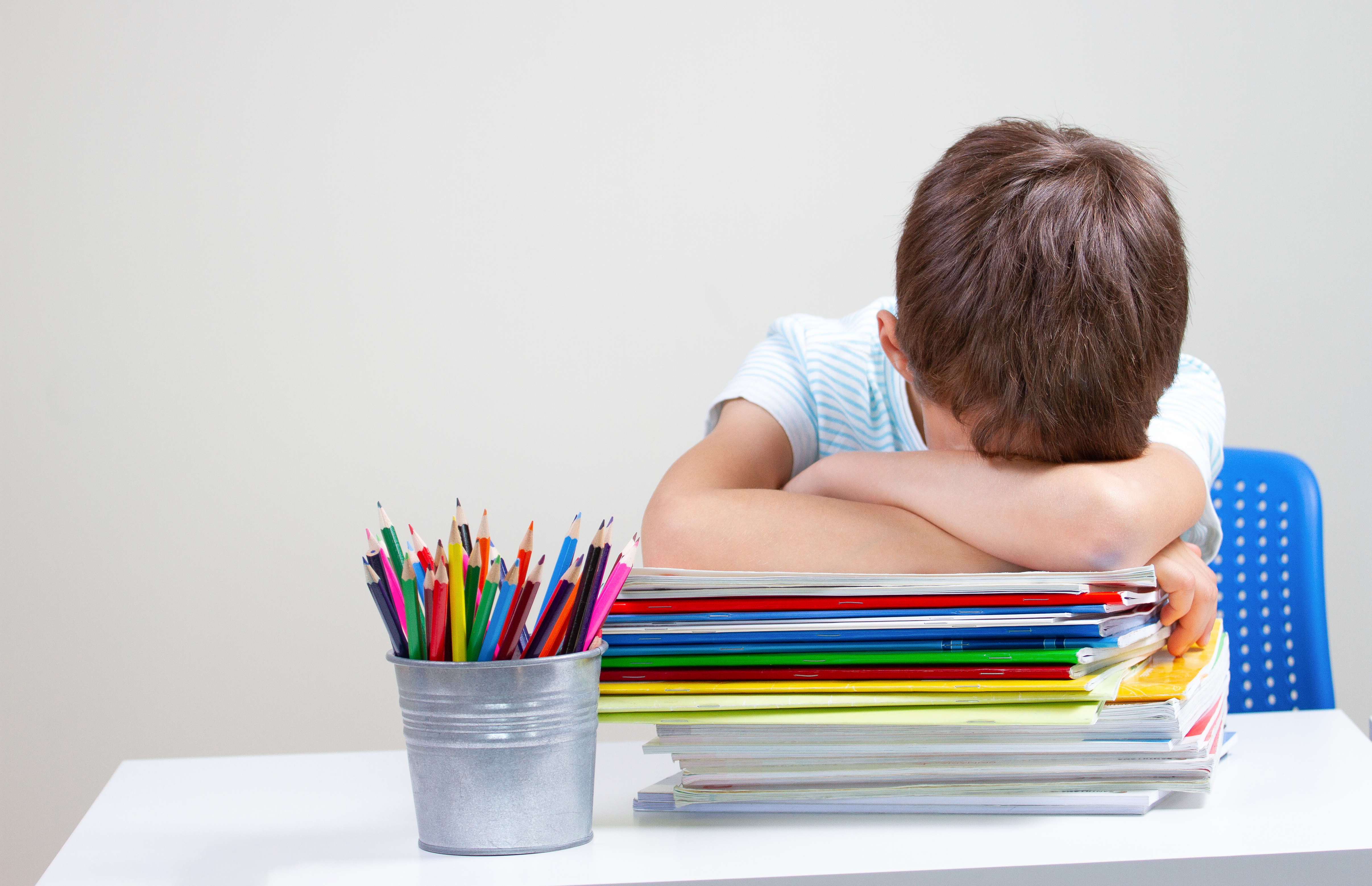 young boy stressed from school work