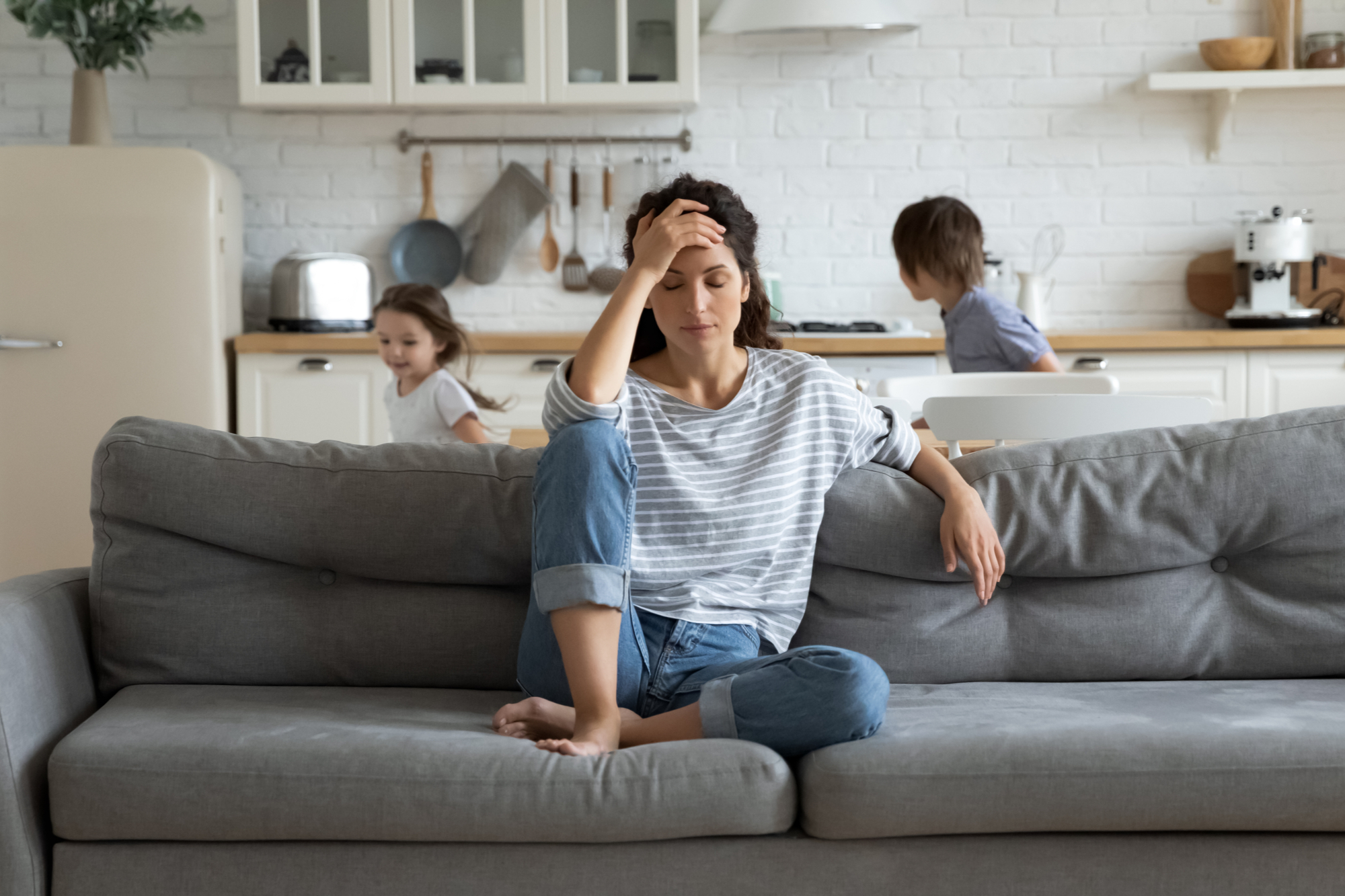 Stressed mom with children running around